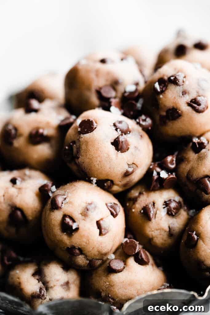 No-Bake Edible Cookie Dough Bites Recipe for Parties 10 A close-up of the cookie dough balls sprinkled with extra chocolate chips and flaky sea salt.