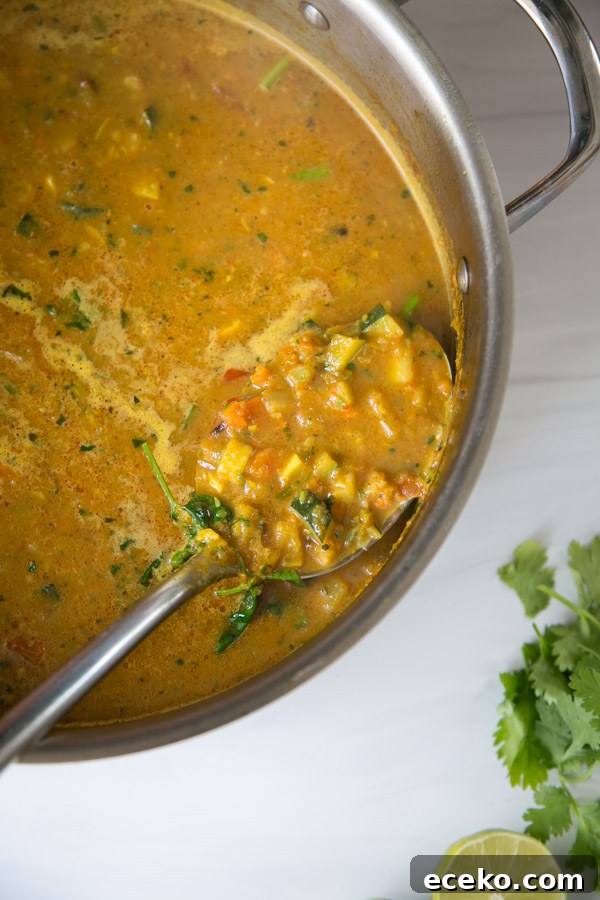 Summer Detox Soup in a pot with zucchini, summer squash and peppers