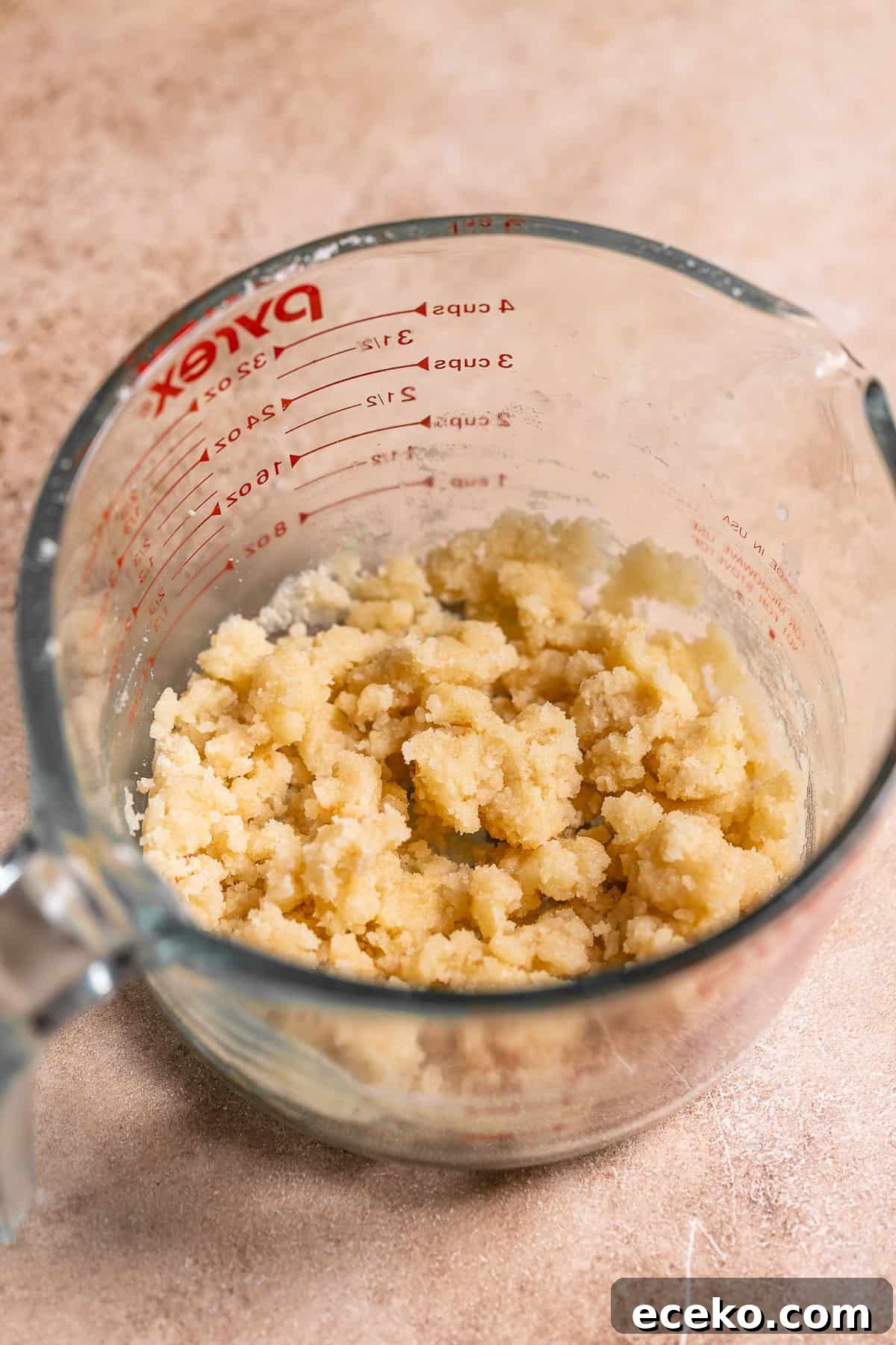 A glass bowl with the crumb topping.