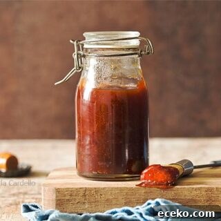 Jar of honey bbq sauce on a cutting board