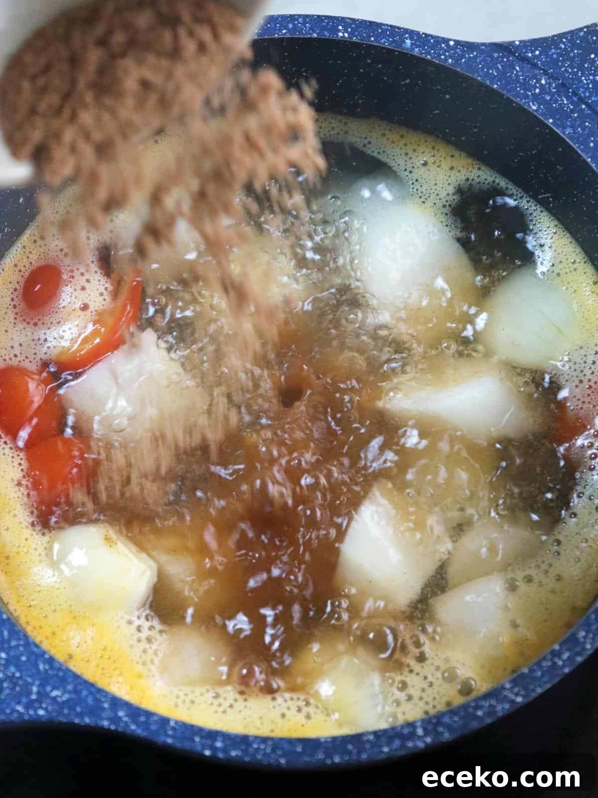 adding tamarind base powder to soup