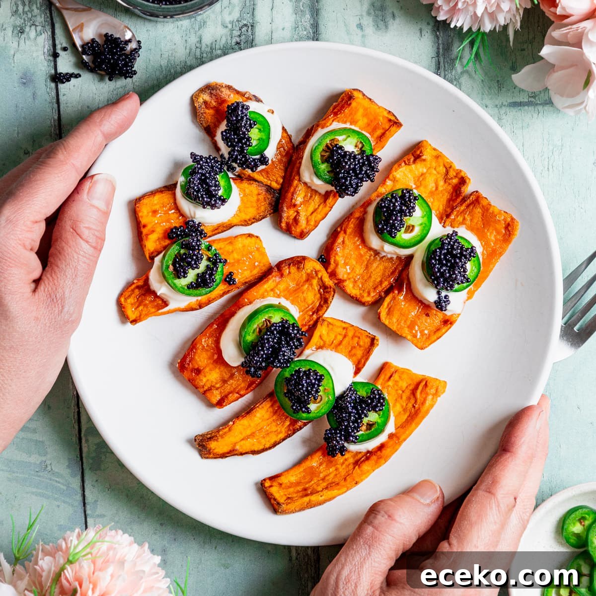 Crispy Air-Fryer Sweet Potato Canapés Topped with Caviar 2 Plate of sweet potato canapes topped with sour cream, chilli pepper and caviar