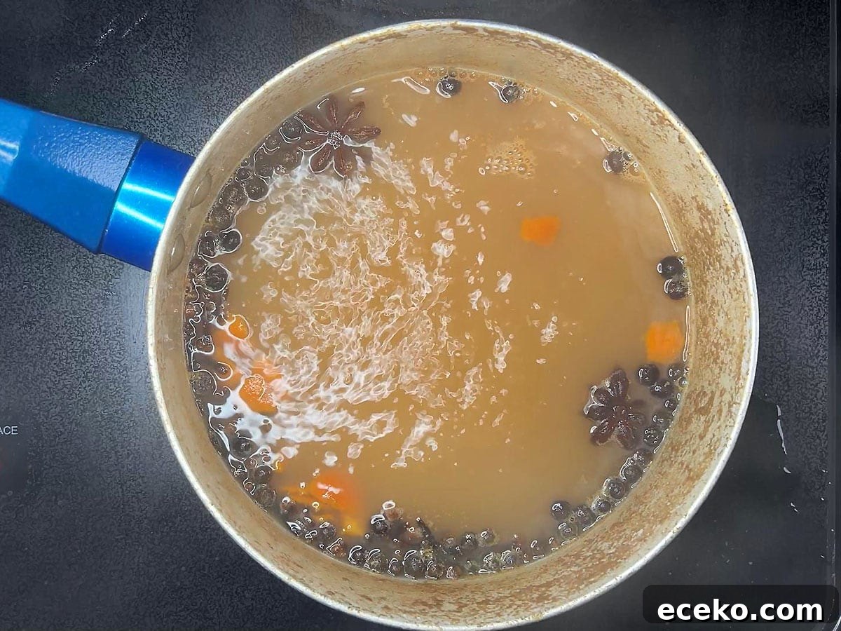 Apple cider after it has simmered with mulling spices for 20 minutes.