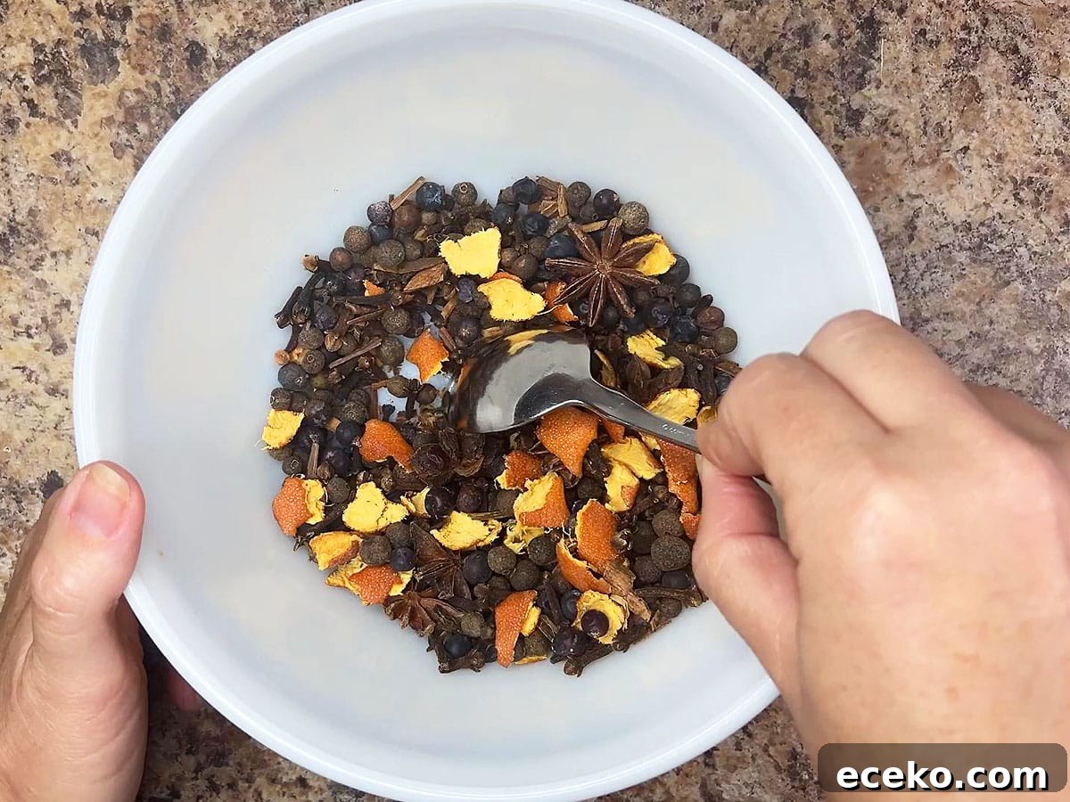 Stirring the mulling spice ingredients together in a small mixing bowl.