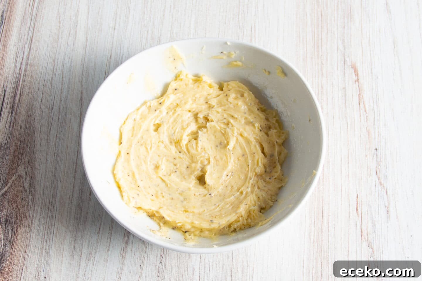 Picture of white bowl with garlic butter.