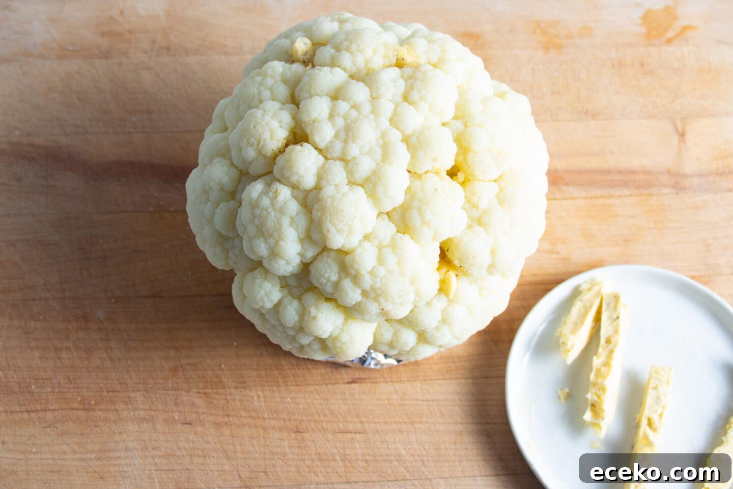 Picture of cauliflower being rubbed with butter.