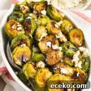 This is a square picture of a bowl of Brussels sprouts with feta and balsamic glaze.