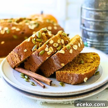 Pumpkin bread sliced on a plate.