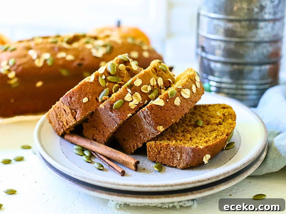Plate with sliced pumpkin bread with cinnamon sticks next to it.