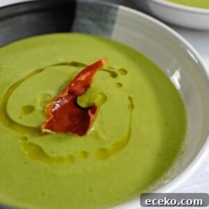 A closeup shot of pea soup with crispy prosciutto on top