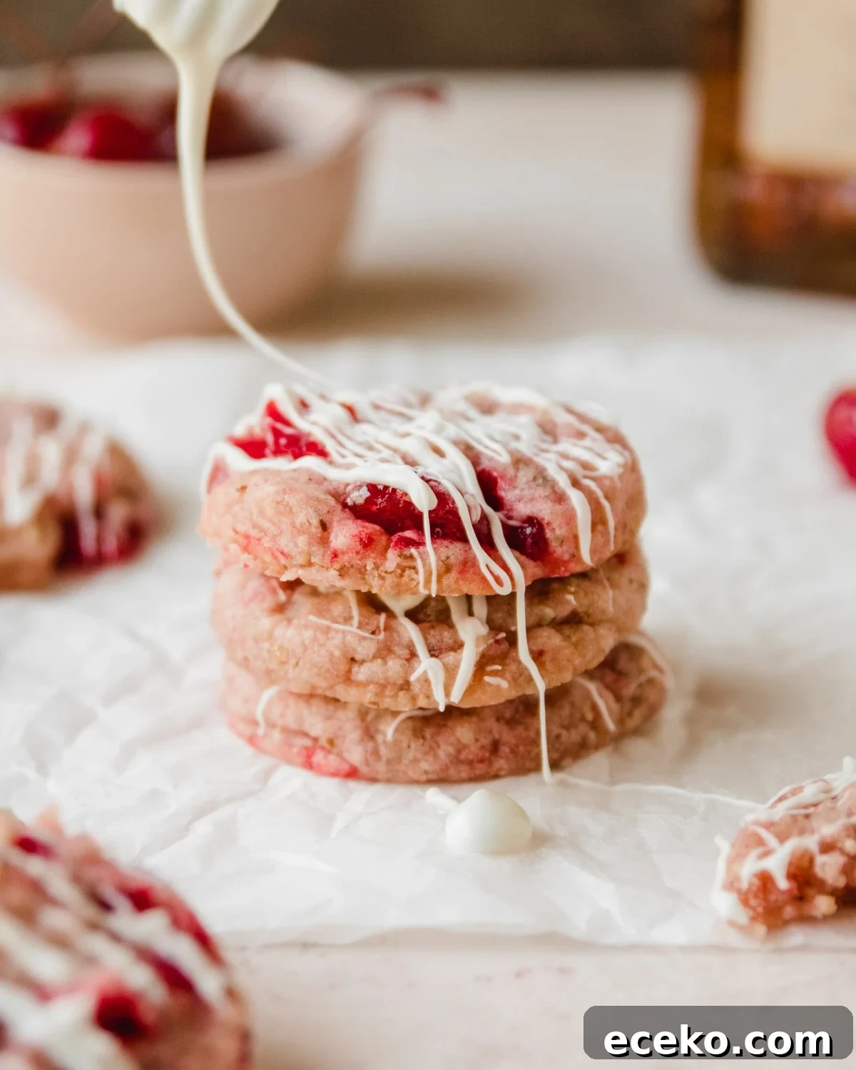 Chewy Cherry Almond Cookies with White Chocolate Chunks 6 Use the tines of a form to drizzle white chocolate over the cookies.