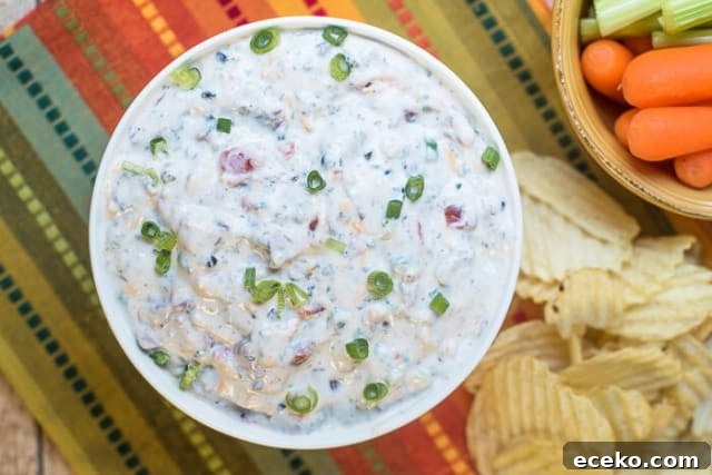 Southwestern Ranch Dip in a white bowl next to chips.