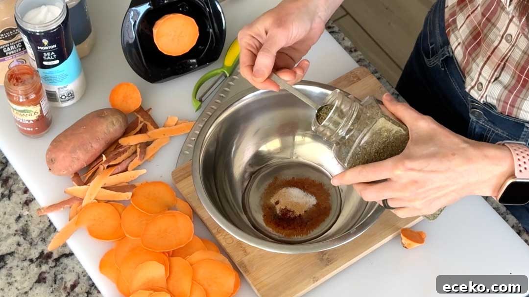Crispy Air Fryer Sweet Potato Chips Recipe 5 Mixing seasonings in a bowl.