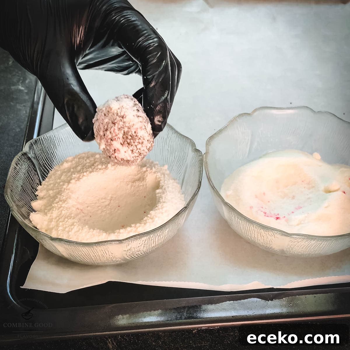Chocolate Peppermint Crinkle Cookies Recipe for the Holidays 16 Hand with black gloves holding dough ball over a bowl filled with powdered sugar.