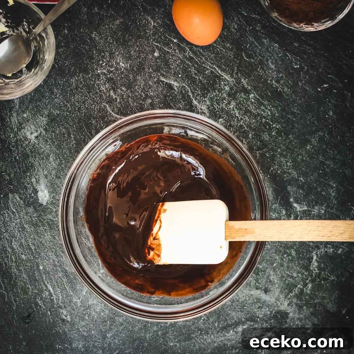 Chocolate Peppermint Crinkle Cookies Recipe for the Holidays 9 Bowl with melted chocolate and spatula.