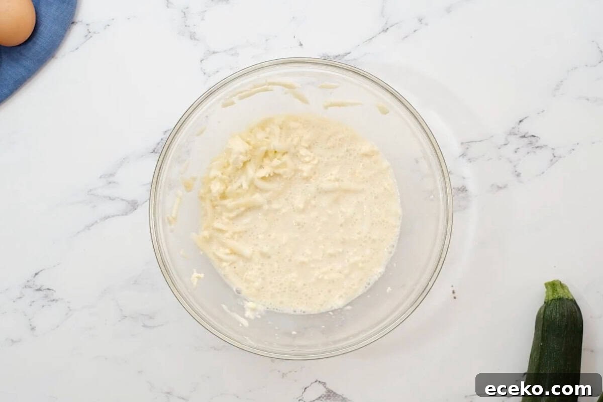 wet ingredients for zucchini cupcakes in a glass bowl.
