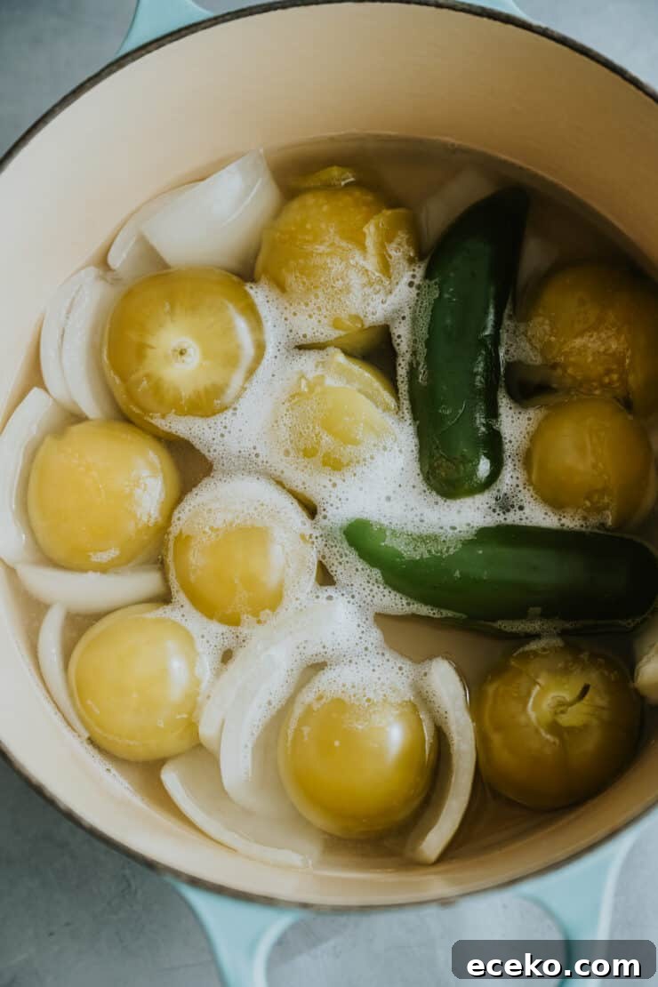 salsa verde ingredients after boiling — the tomatillos look more yellow than before.