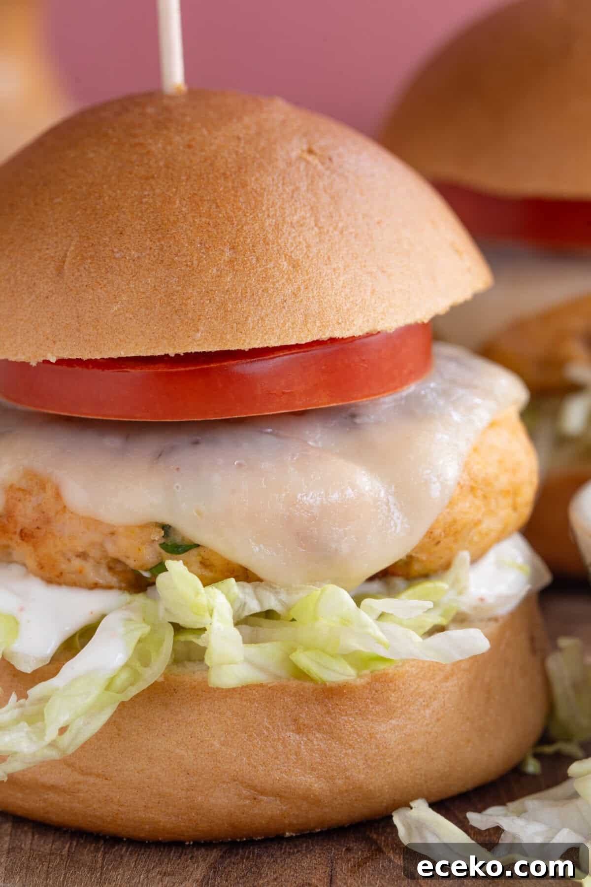A finished chicken burger in a bun.