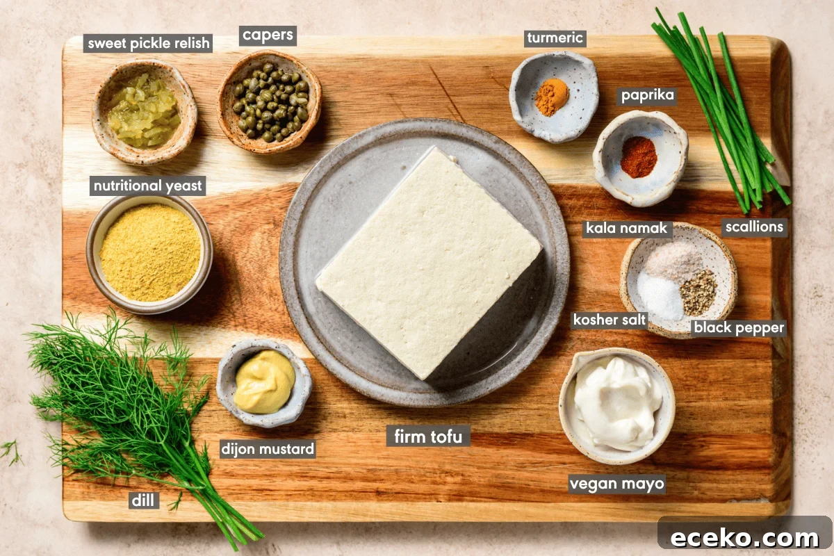 Vegan egg salad ingredients in various small bowls on a wooden cutting board.