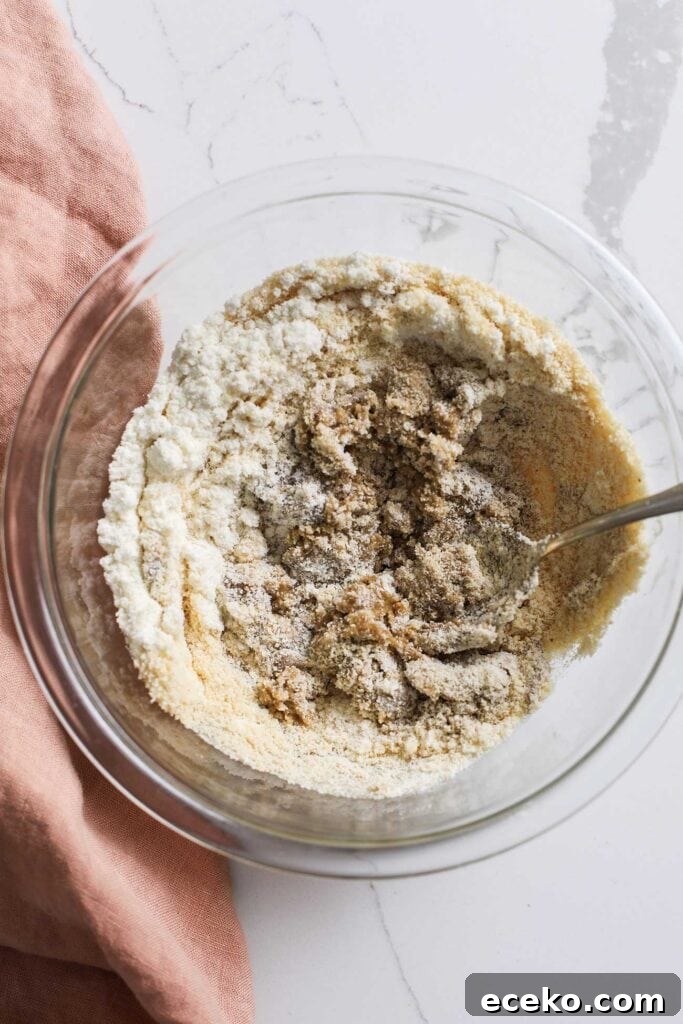 A dry, dense cookie dough shown in a bowl.