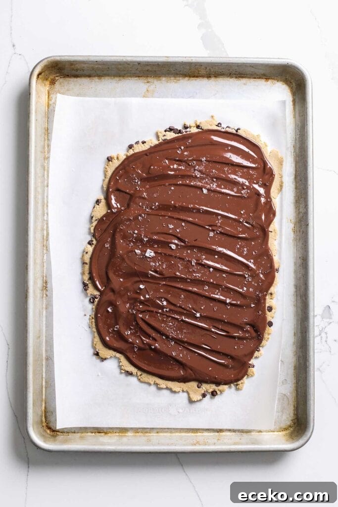 A thin layer of chocolate spread out over the cookie dough layer.