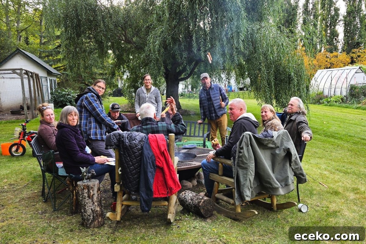 Lots of people sitting around the campfire after an apple cider pressing work bee.