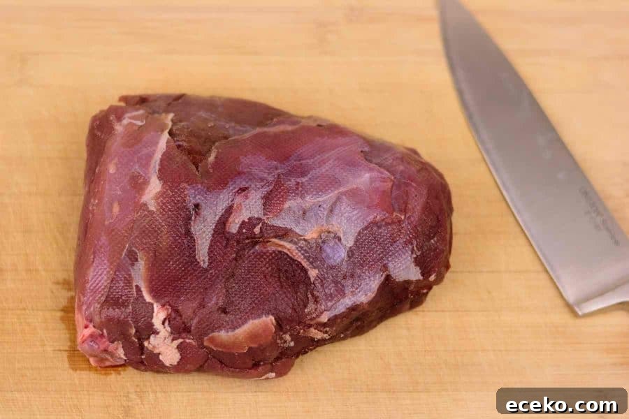 Rosemary-Pear Venison Jerky Recipe for Flavorful Snacks 4 Venison Roast on cutting board with knife