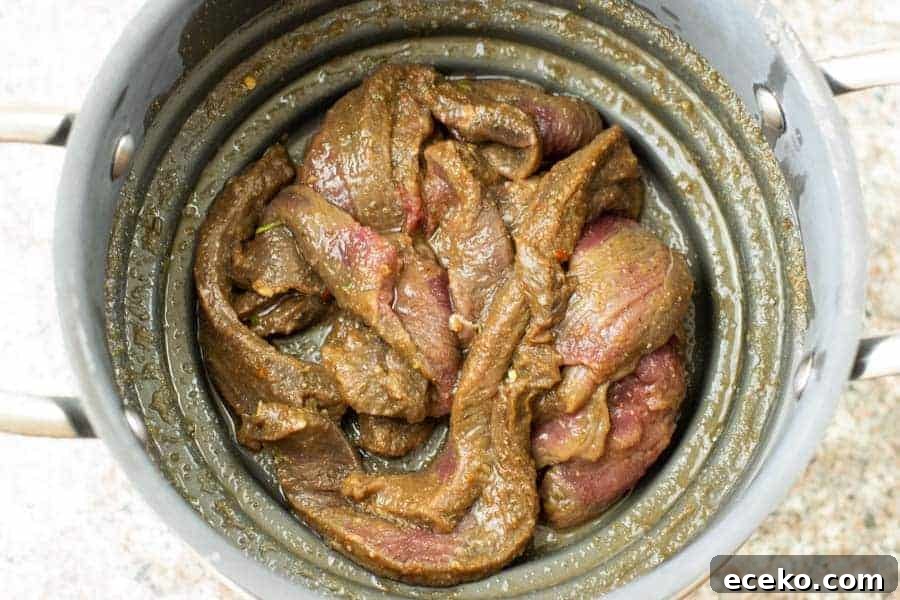 Rosemary-Pear Venison Jerky Recipe for Flavorful Snacks 9 deer jerky straining of marinade in colander