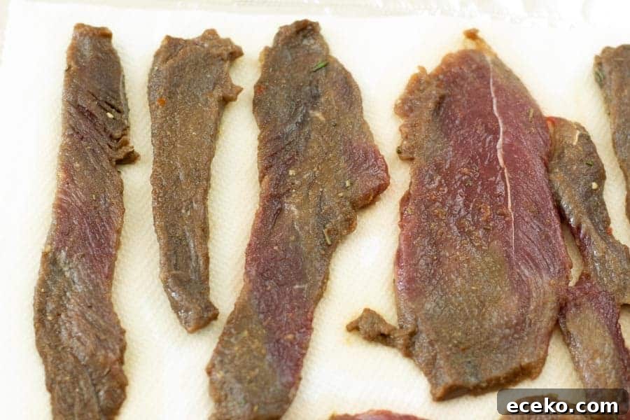 Rosemary-Pear Venison Jerky Recipe for Flavorful Snacks 10 Venison jerky drying on paper towels