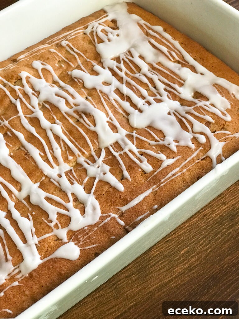 Cinnamon Applesauce Cake Recipe with Moist Spice and Quick Prep 3 Cinnamon Applesauce Coffee Cake with a light icing in a baking pan