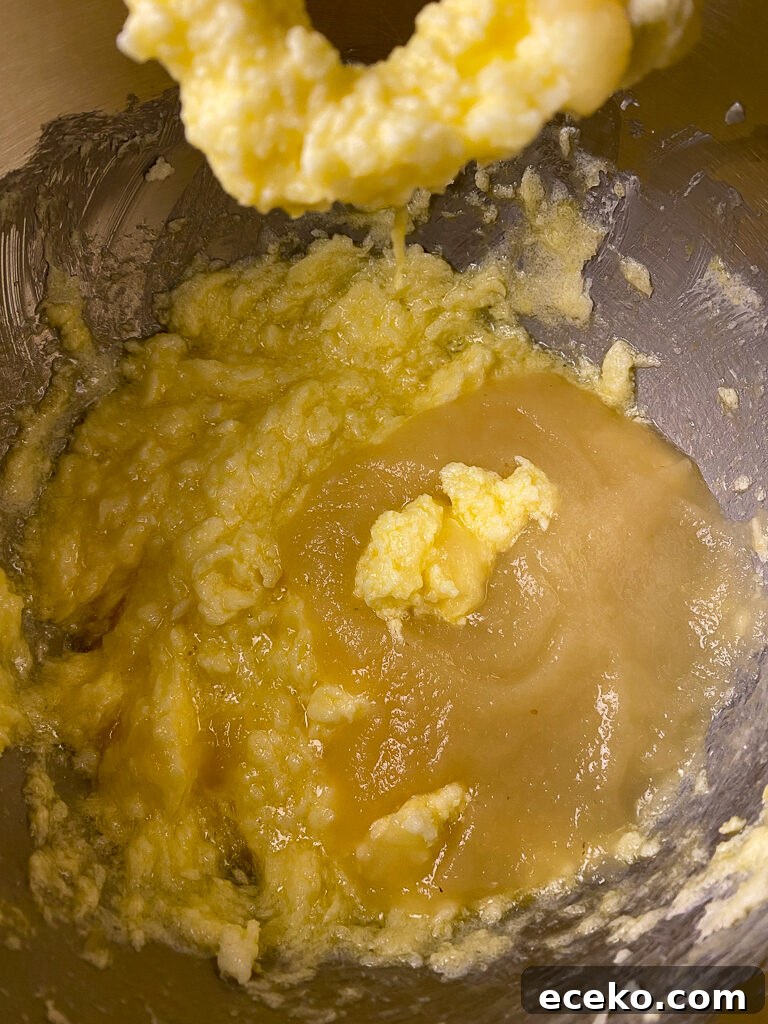 Cinnamon Applesauce Cake Recipe with Moist Spice and Quick Prep 8 Applesauce being added to butter and eggs mixture in a metal bowl
