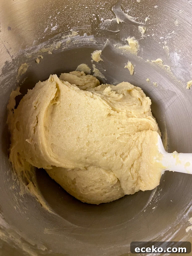 Cinnamon Applesauce Cake Recipe with Moist Spice and Quick Prep 10 Applesauce coffee cake batter being stirred with a silicone spatula