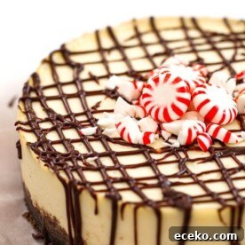 Instant Pot White Chocolate Peppermint Cheesecake garnished with peppermint candies on white background