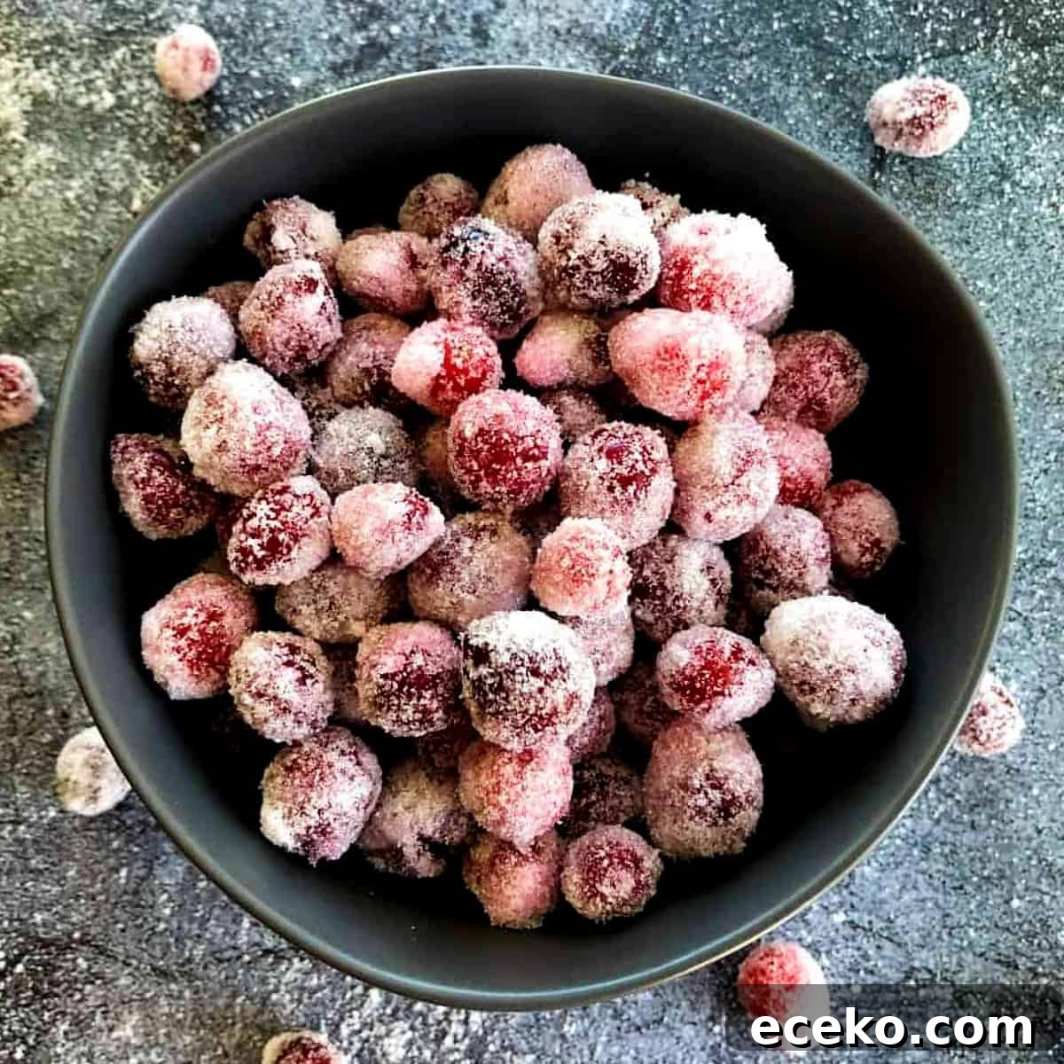 boozy-candied-cranberries-in-a-bowl-with-sugar
