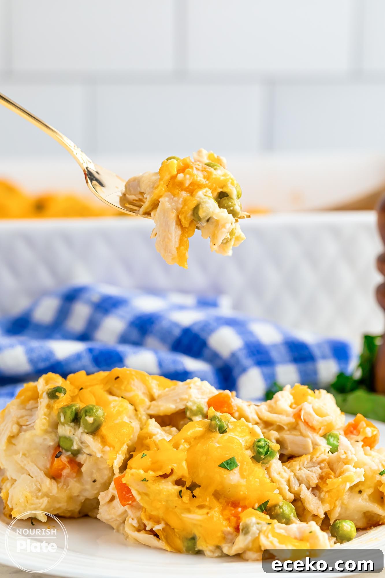 Chicken Pot Pie Bubble-Up Casserole Recipe for Cozy Dinners 10 Easy Chicken Pot Pie Bubble Up Casserole served on a white plate, with a fork taking a little