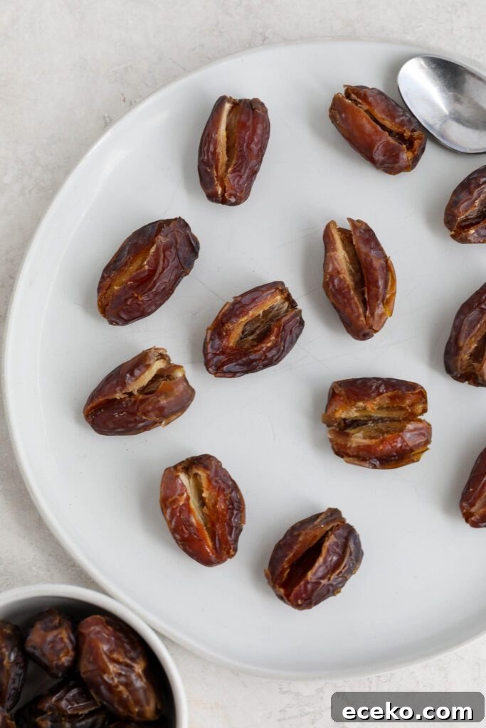dates split in half on plate with pits removed