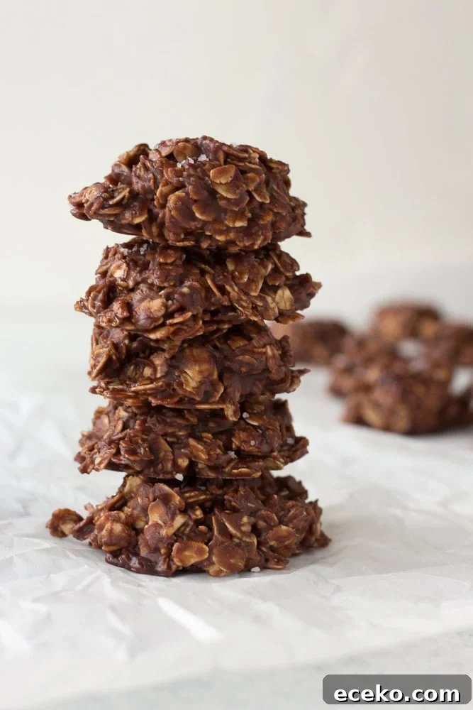 No-Bake Chocolate Peanut Butter Oatmeal Cookies – Gluten Free 13 stack of no bake chocolate oatmeal peanut butter cookies on white parchment