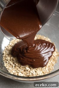No-Bake Chocolate Peanut Butter Oatmeal Cookies – Gluten Free 6 pouring chocolate over oats in a bowl