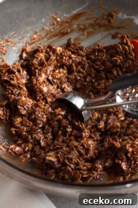 No-Bake Chocolate Peanut Butter Oatmeal Cookies – Gluten Free 8 scooping chocolate oat mixture out of a bowl