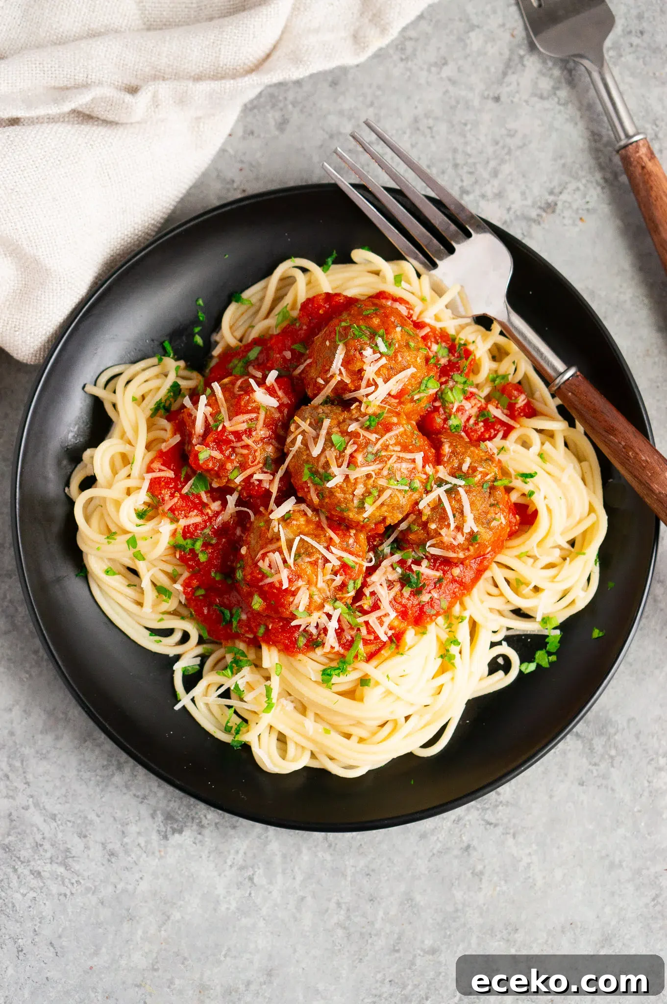 italian meatballs with marinara sauce over spaghetti on a plate