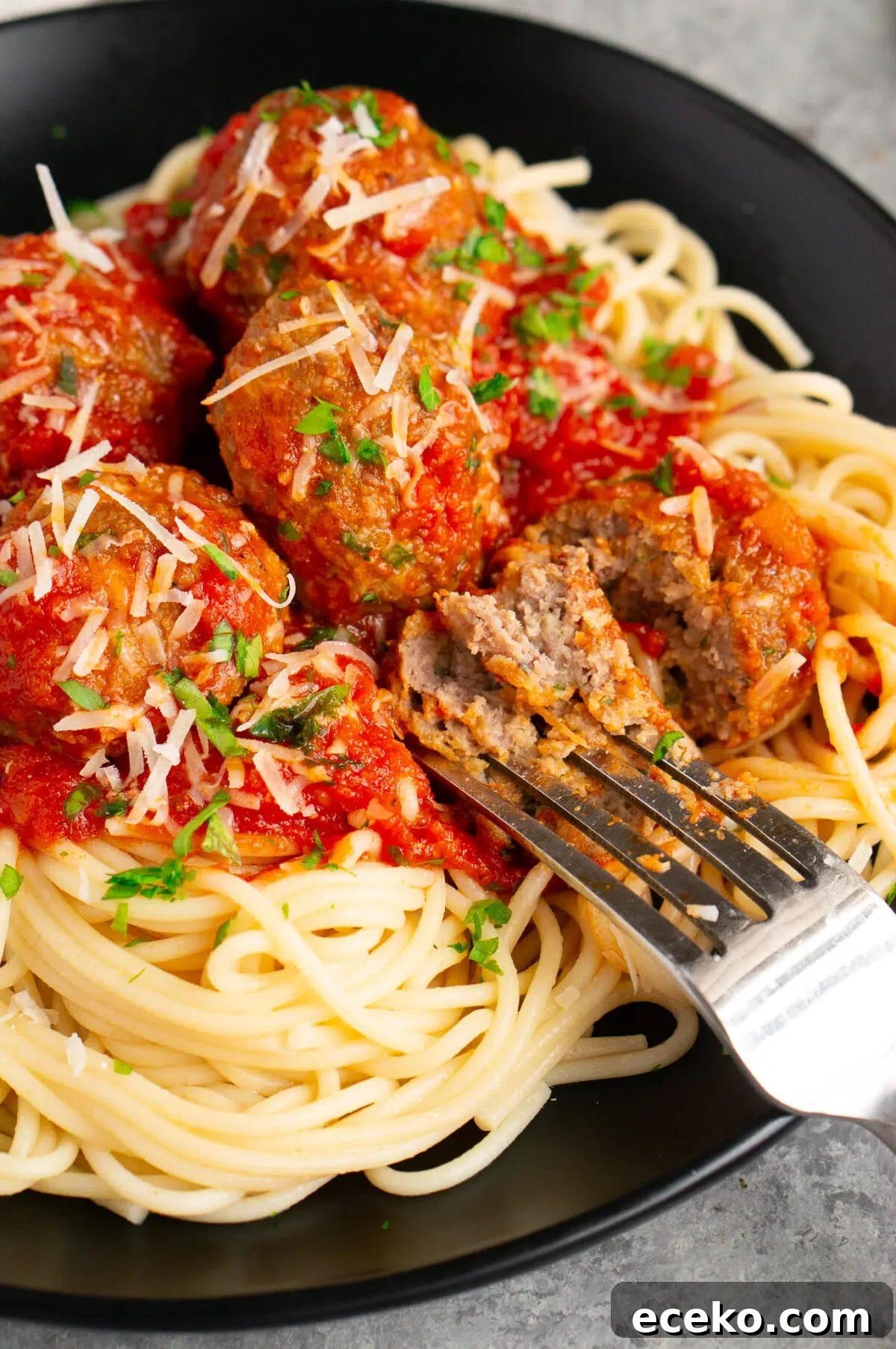meatball cut in half with a fork