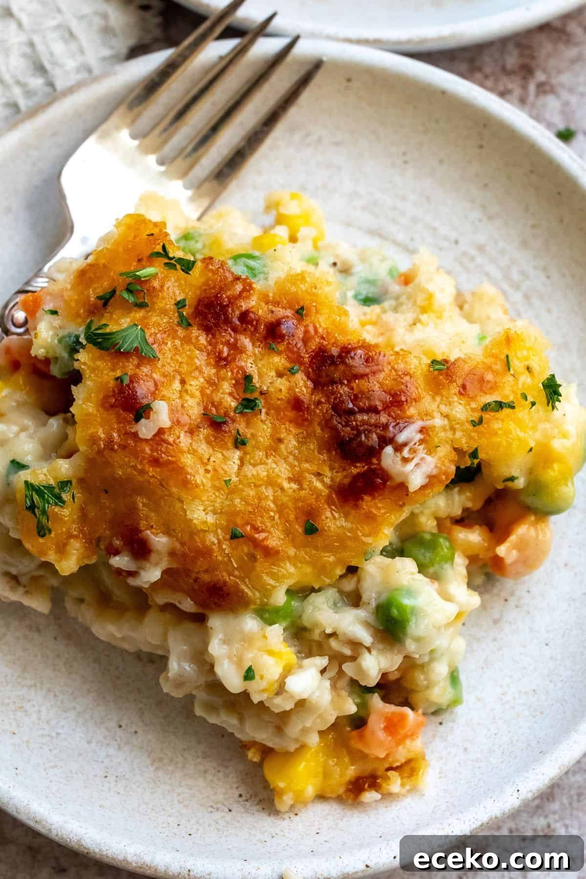 A close up image of a slice of chicken cobbler casserole.