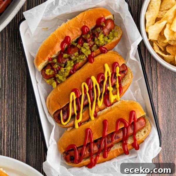 Smoky Burnt Ends Hot Dogs: Crispy, Charred BBQ Bites 13 Grilled Hot Dogs on a parchment paper lined pan