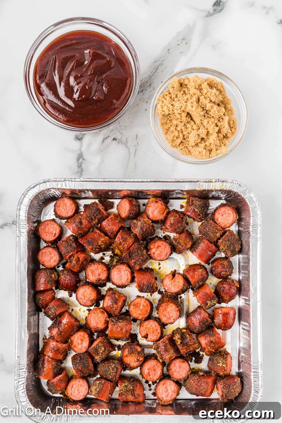 Smoky Burnt Ends Hot Dogs: Crispy, Charred BBQ Bites 7 Hot dogs cut into bite size pieces in a disposable foil with a bowl of BBQ Sauce and brown sugar