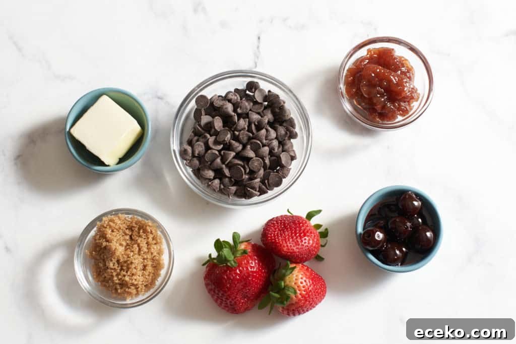Three strawberries and small bowls of butter, brown sugar, chocolate chips, cherries, and jam.