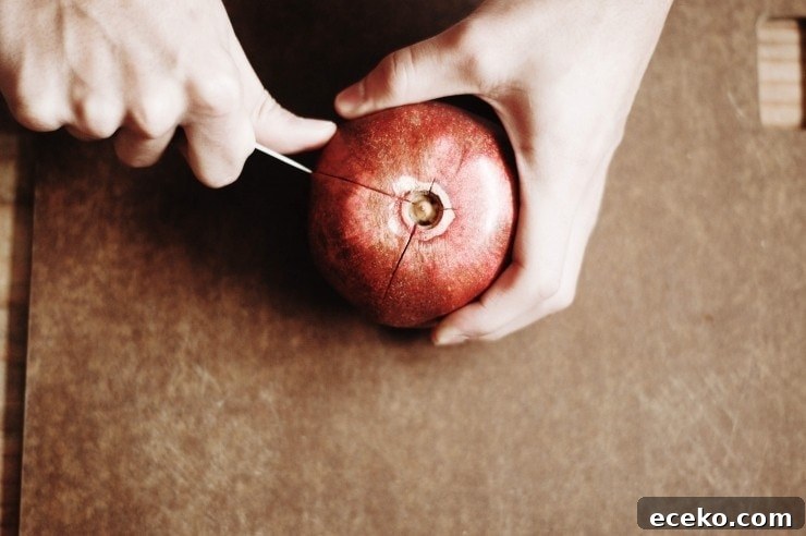 How to Remove Pomegranate Seeds Quickly and Cleanly 2 Cutting a pomegranate fruit into sections with a paring knife