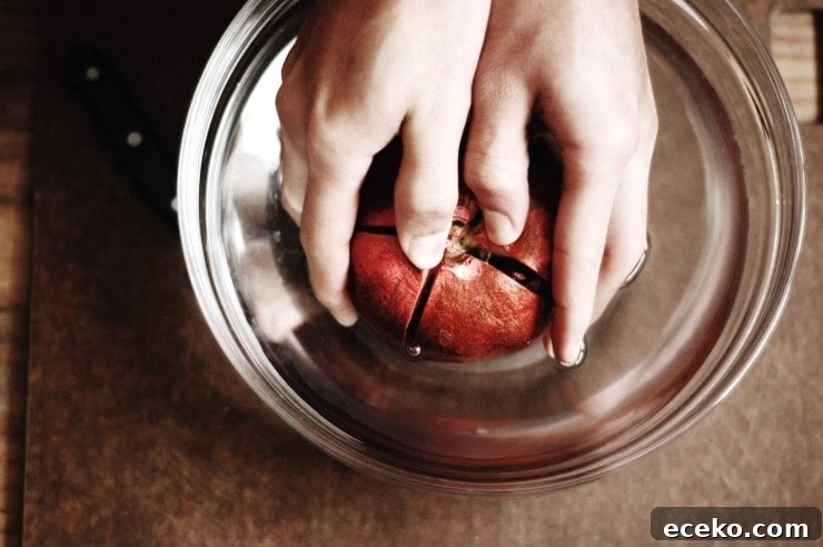How to Remove Pomegranate Seeds Quickly and Cleanly 3 Separating cut pomegranate sections in water
