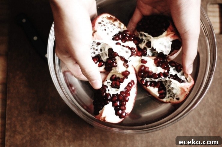 How to Remove Pomegranate Seeds Quickly and Cleanly 4 Segmented fruit in a bowl of water