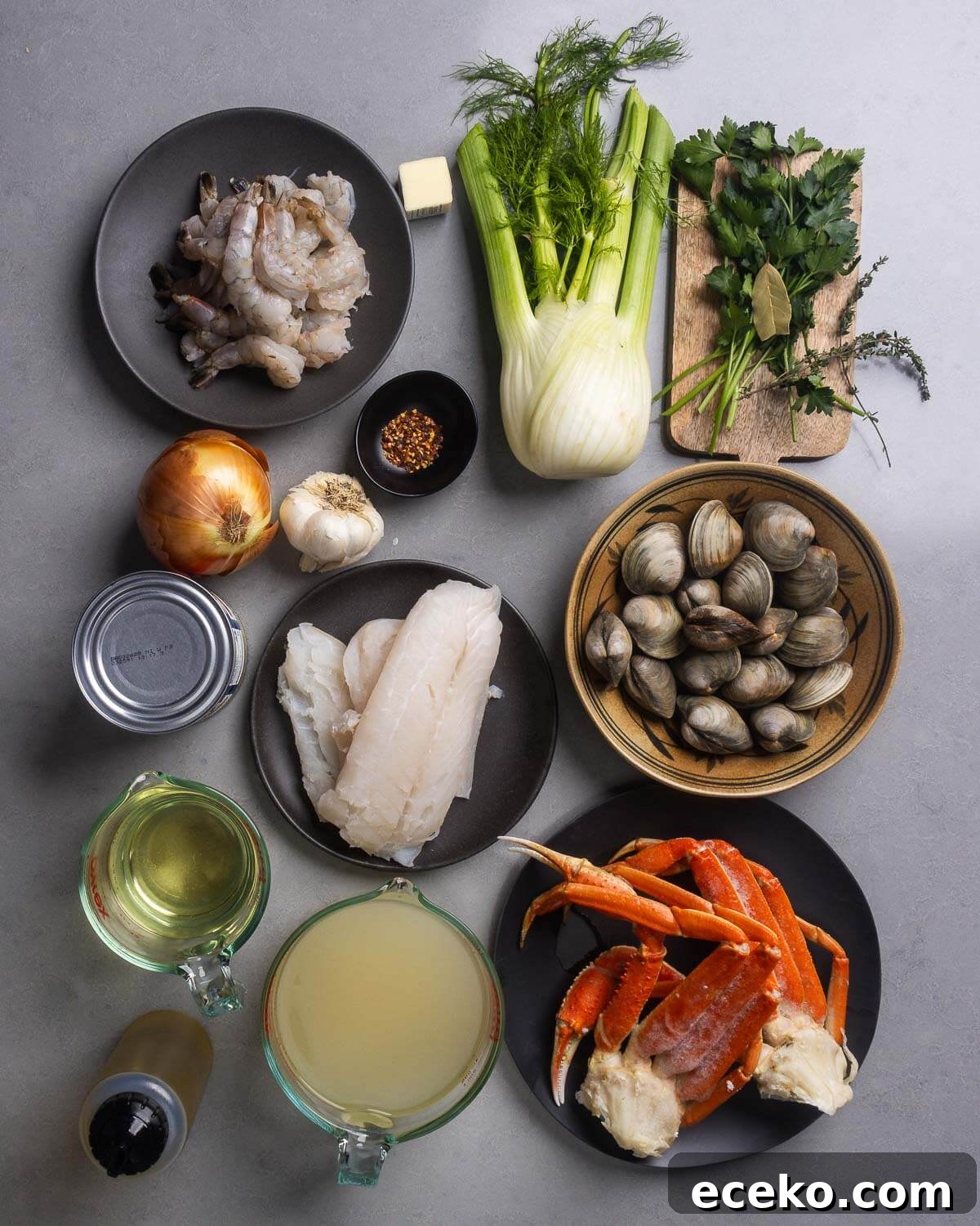 Authentic Cioppino: San Francisco-Style Seafood Steewith Shellfish 4 Ingredients shown: shrimp, crushed red pepper flakes, fennel, parsley, bay leave, thyme, onion, garlic, canned tomatoes, cod, clams, wine, olive oil, clam juice, and crab legs.