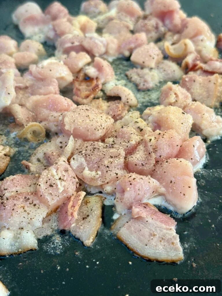 adding chicken to the griddle